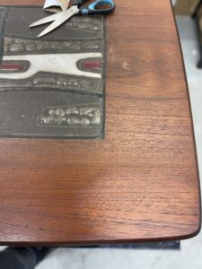 Tests de finition sur une table basse en teck de Louis van Teeffelen restauré à l'Atelier Roba - Paris - Hauts de Seine